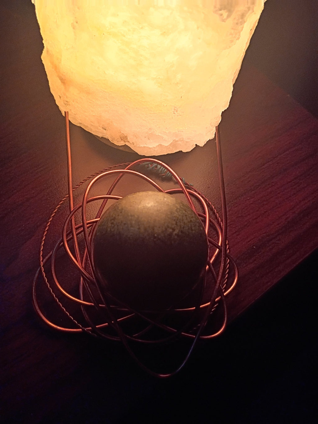 The original lab piece behind the Jaded Hoodie: a jade sphere wrapped in copper wire beneath a glowing crystal